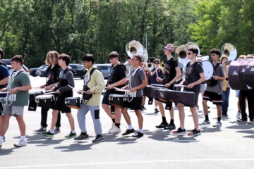 Drummers and other musicians playing and marching